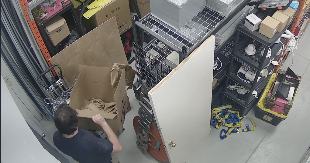 Person opening box in warehouse